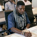 Young adults engaged in study session in a modern education setting.