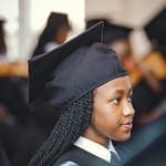 Portrait of a young graduate in cap and gown during a ceremony in Nairobi, Kenya.